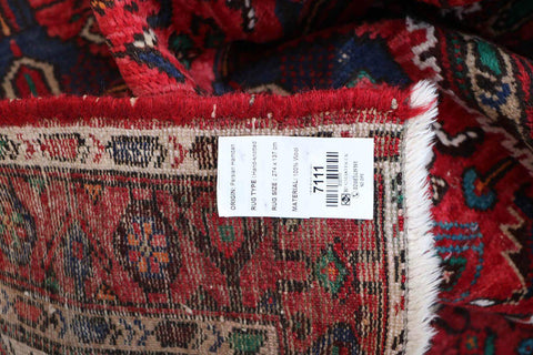 A long, rectangular, red wool rug 