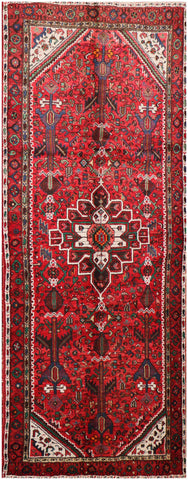 A long, rectangular, red wool rug 