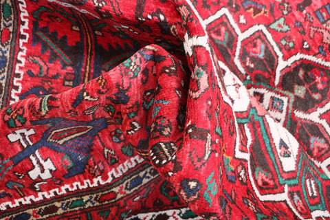 A long, rectangular, red wool rug 
