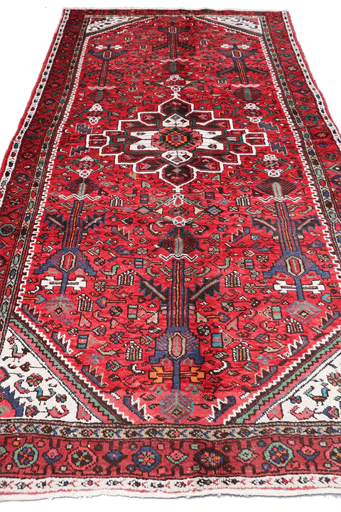 A long, rectangular, red wool rug 