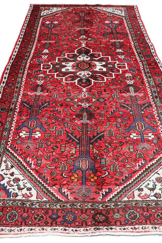 A long, rectangular, red wool rug 