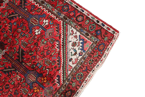 A long, rectangular, red wool rug 