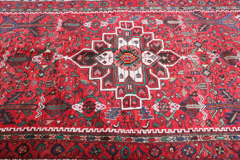 A long, rectangular, red wool rug 