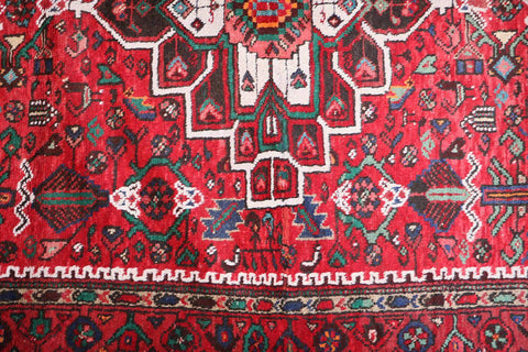 A long, rectangular, red wool rug 