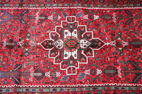 A long, rectangular, red wool rug 