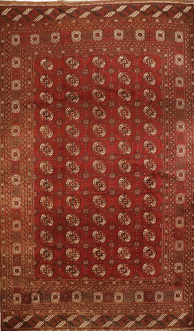A red and beige colored Afghan wool rug 